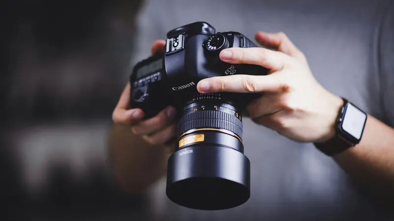 Close view of hands adjusting a camera lens