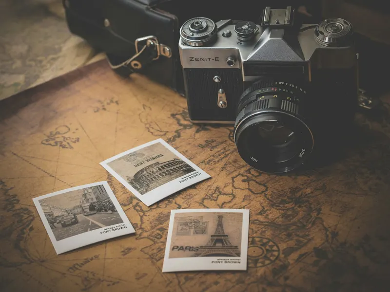 Vintage camera with printed photographs on a map